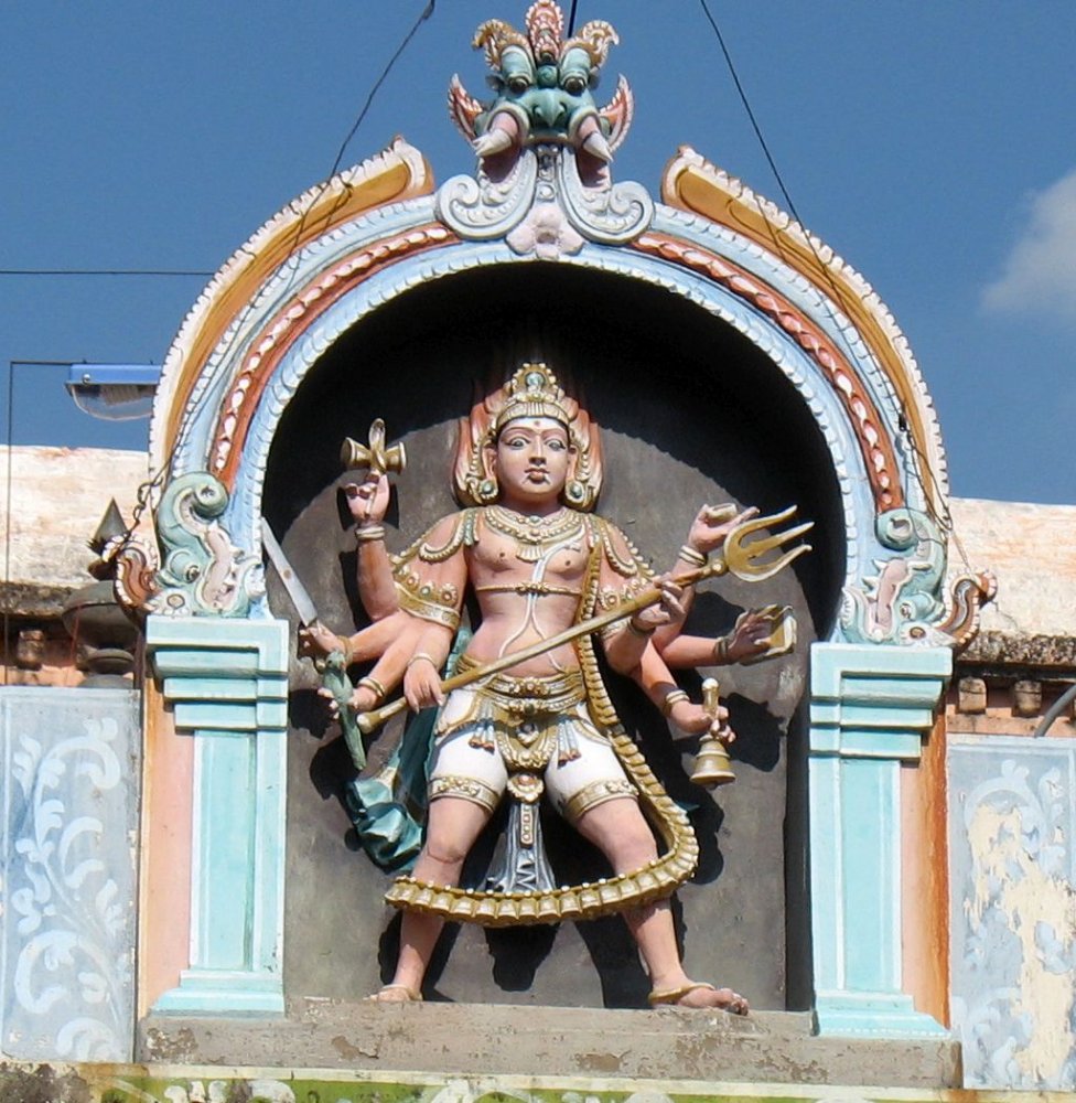 kalabhairava sculpture on top of his temple shrine