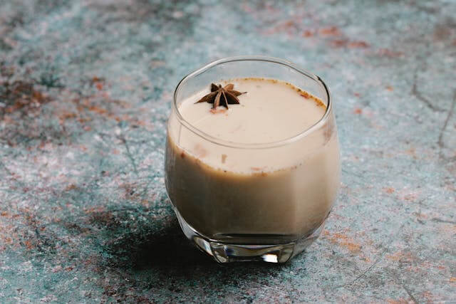 glass with chai spice tea on gray table